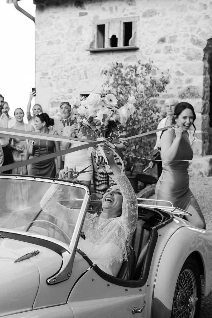 Wedding guests taking part in a traditional ribbon pull during a wedding in Beaujolais