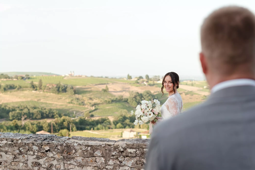 Bride looking at the groom in the sunset light in Beaujolais